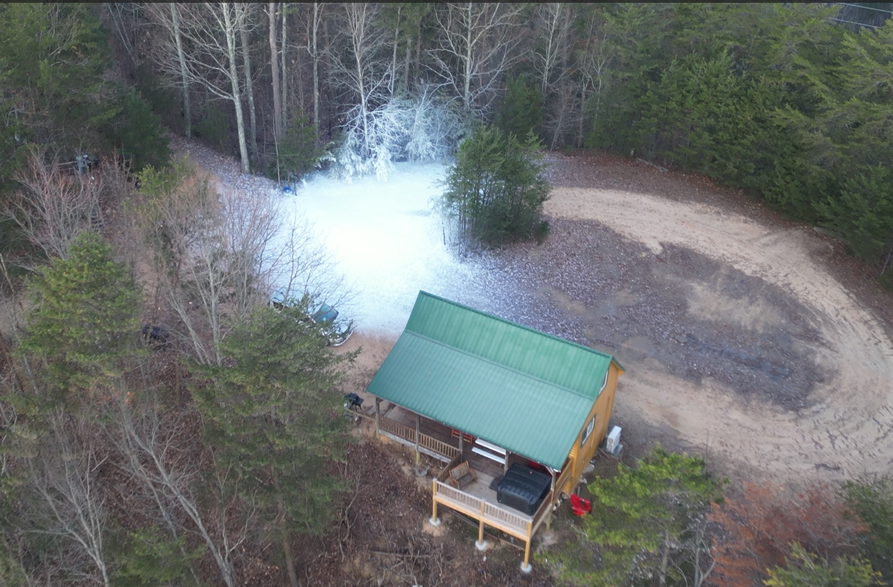 Drone shot of snow-covered cabin